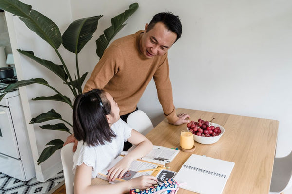 Father and daughter discussing a schoolwork question together